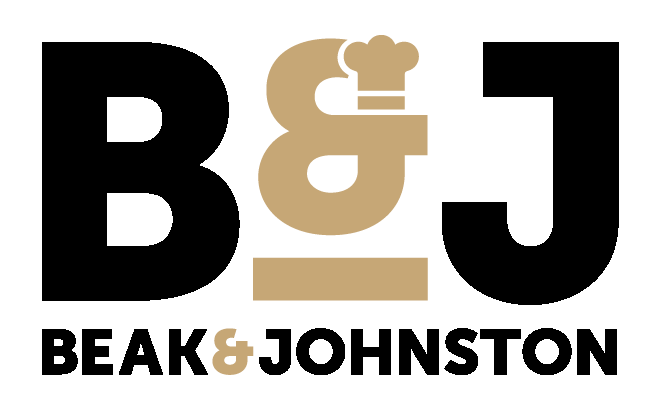 A man and woman smile warmly at the camera