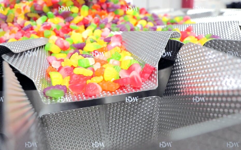 A woman sits at a table, preparing for her nail service.